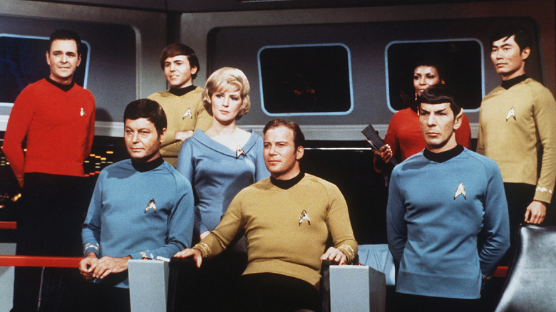 The Starship Enterprise crew sitting assembled together on the bridge of the ship