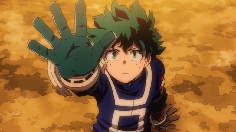 Deku holding up his hand