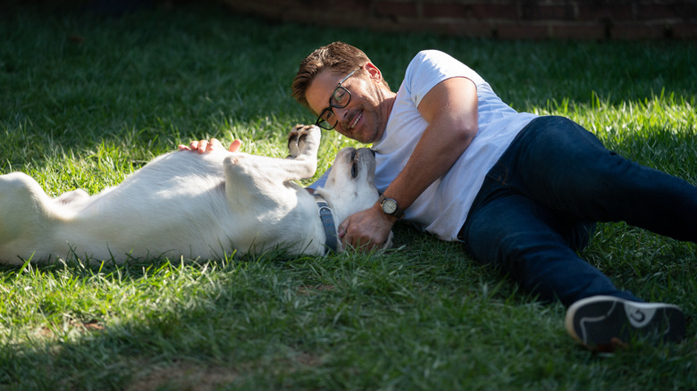 John playing with Gonker in the grass