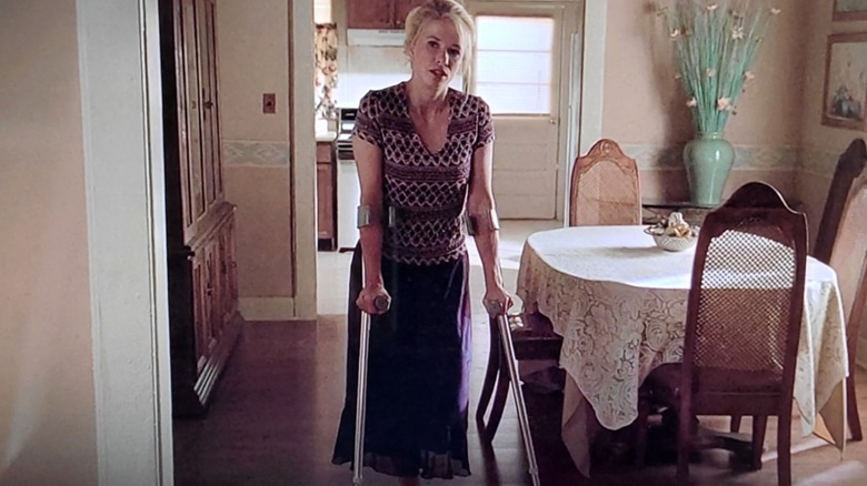 Svetlana Kirilenko stands with crutches 