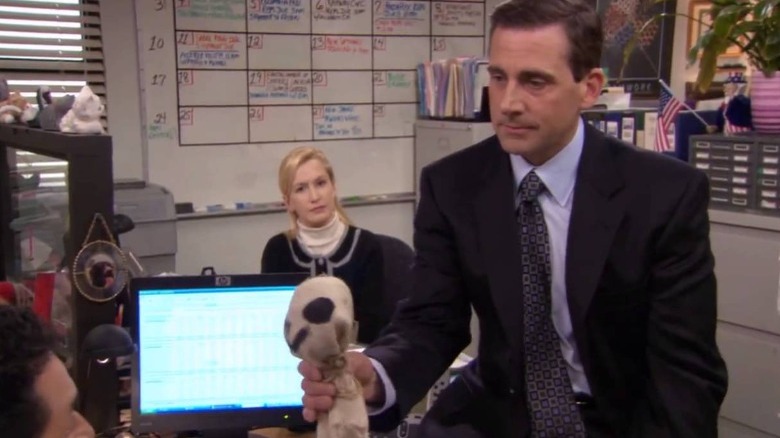 Michael Scott holding doll