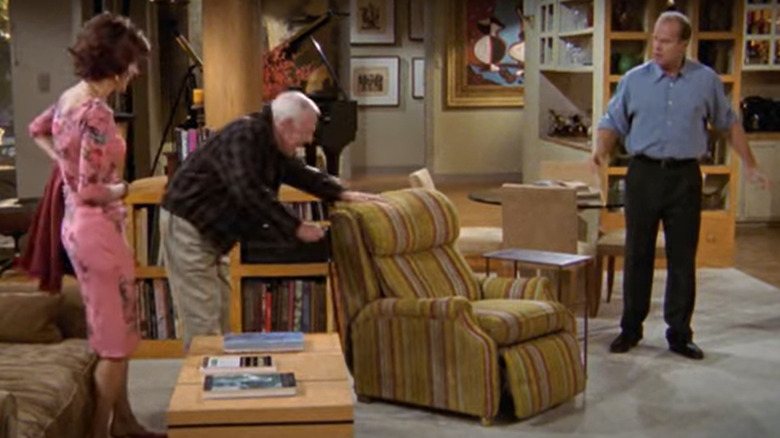 Martin Crane touching his armchair