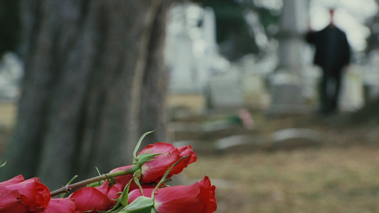 Rocky in distance waving to Adrian's grave