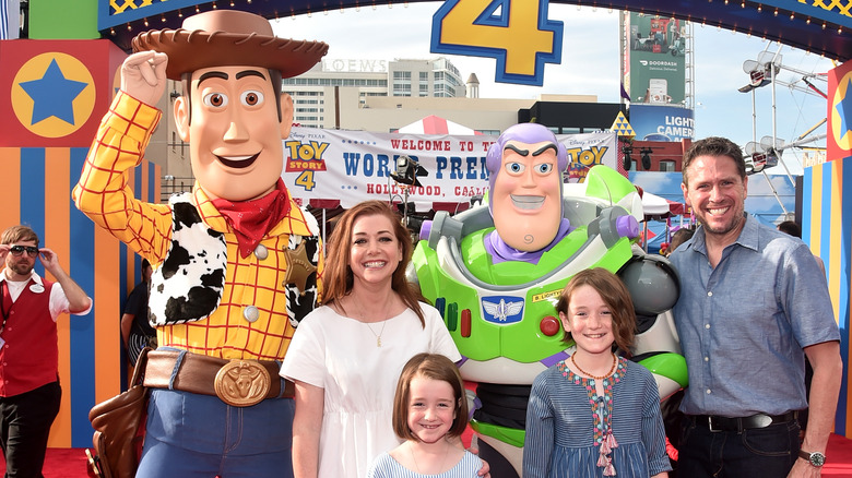 Hannigan and Alexis Denisov with daughters and friends smiling