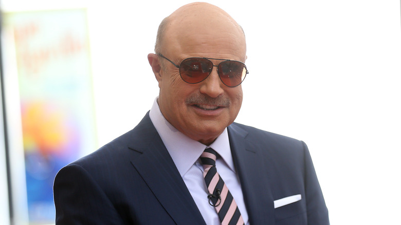 Phil McGraw wearing sunglasses smiling