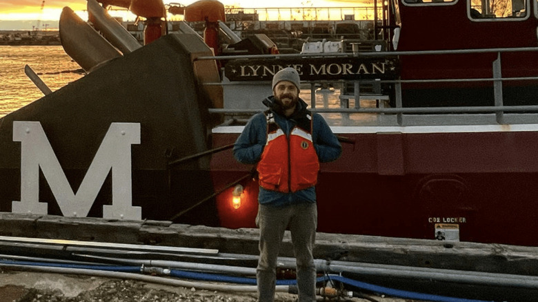 Eddie in front of boat