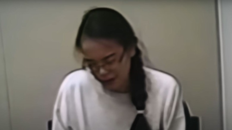 Jennifer Pan sitting looking sad