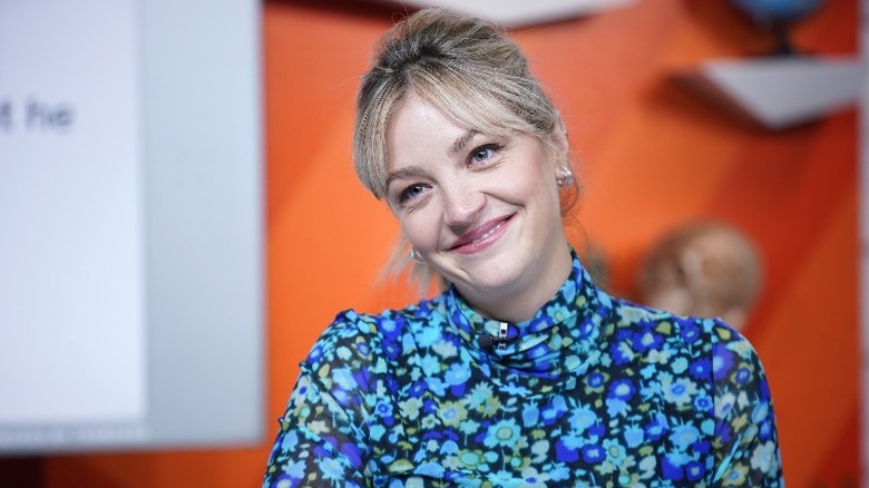 Abby Elliott smiling with a cocked head