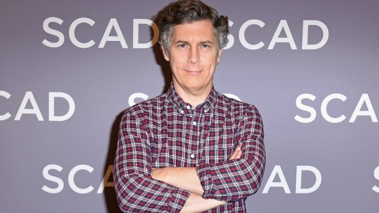 Chris Parnell smirking with crossed arms