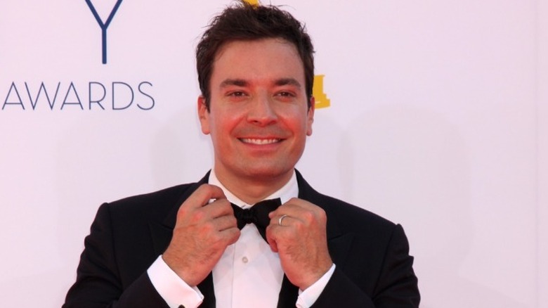 Jimmy Fallon playing with his bowtie, smiling