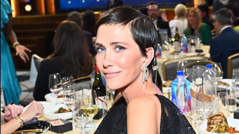 Kristen Wiig at a table at an awards show