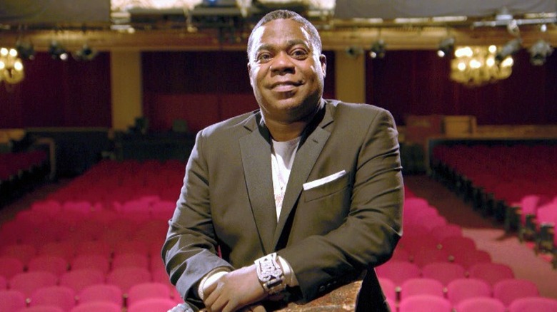 Tracy Morgan, smiling in an empty auditorium 