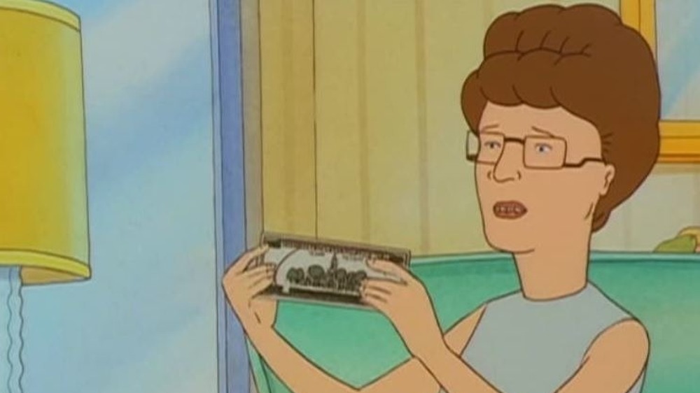 Peggy Hill holding money