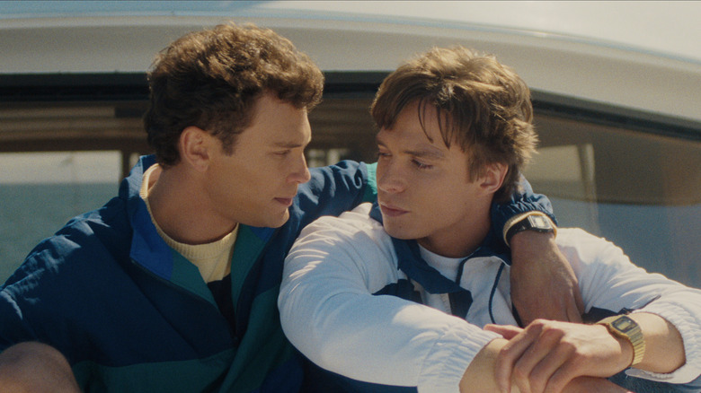 Cooper Koch as Erik Menendez and Nicholas Chavez as Lyle Menendez embracing on a boat in "Monsters: The Lyle And Erik Menendez Story."