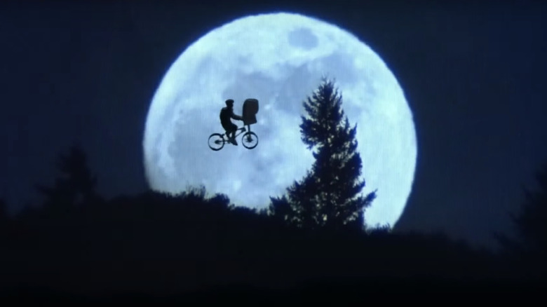 Elliott and E.T. flying over the moon