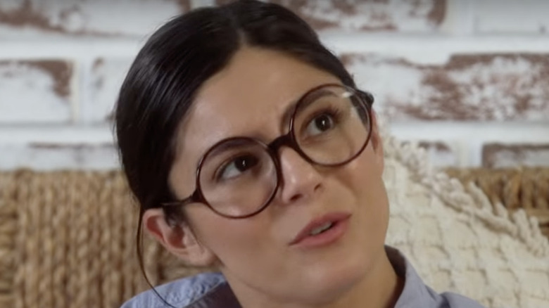 Monica Barbaro with glasses