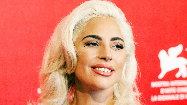 Lady Gaga blonde red backdrop