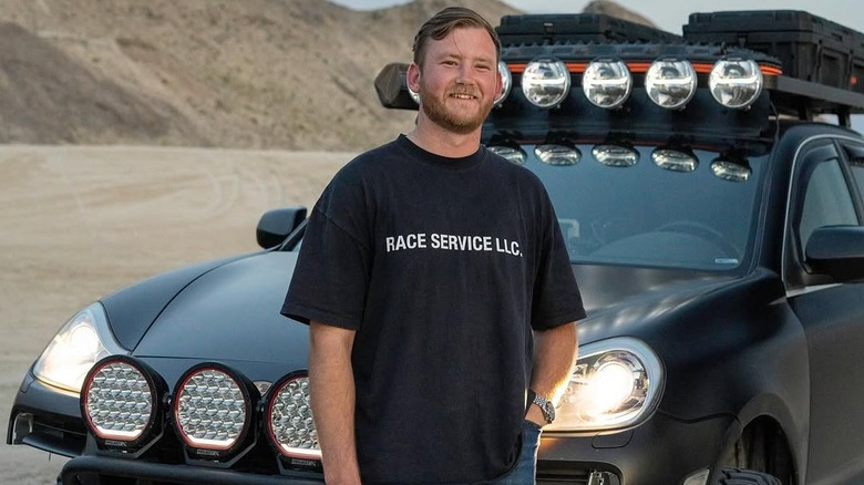 Harrison Schoen standing in front of a tricked-out vehicle