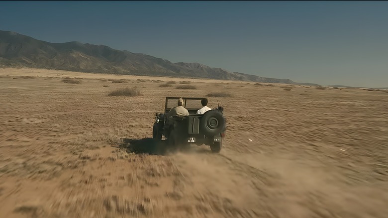 Oppenheimer is driven through desert