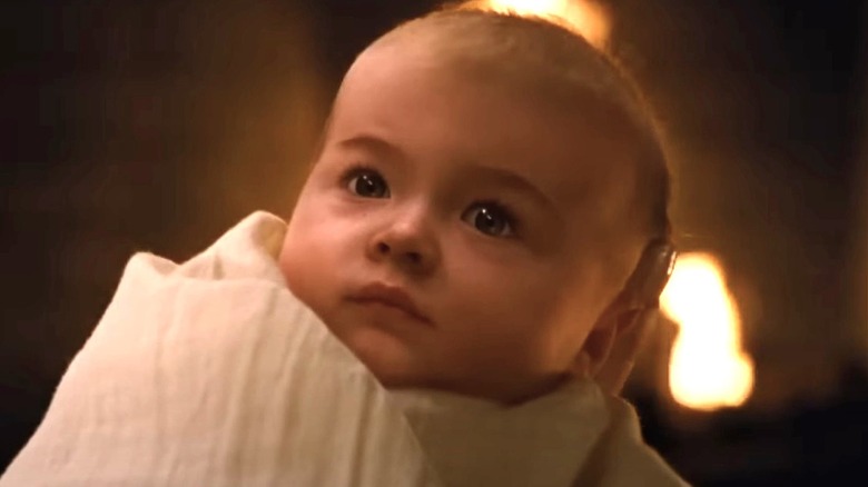 Baby Renesmee looking up in white blanket 