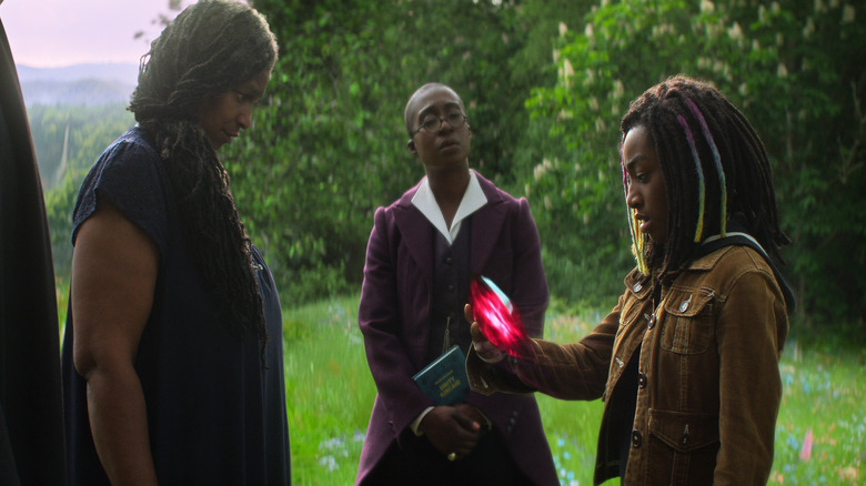 Rose Walker holding a red stone