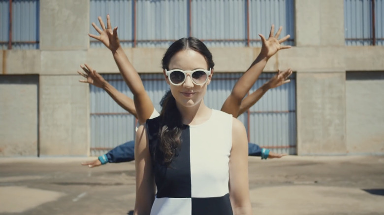 Jain wearing sunglasses and a black and white dress