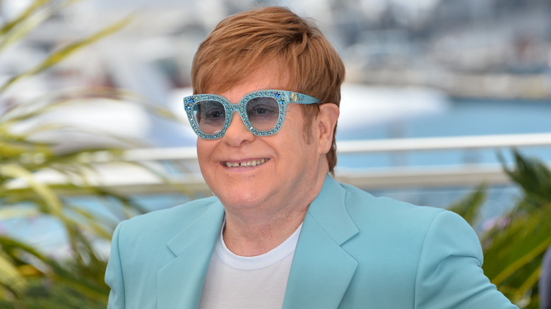 Elton John at event smiling