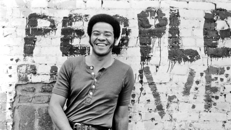 Bill Withers leaning against wall