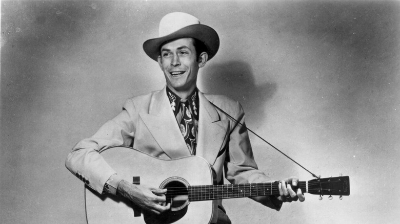 Country star Hank Williams poses with a guitar