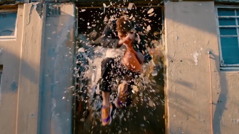 Man jumping through a window