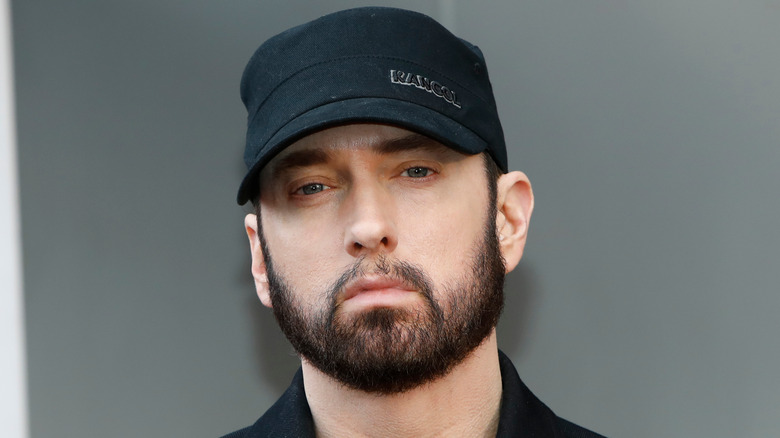 Eminem wearing black baseball cap