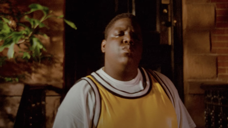 Notorious B.I.G. wearing a yellow jersey