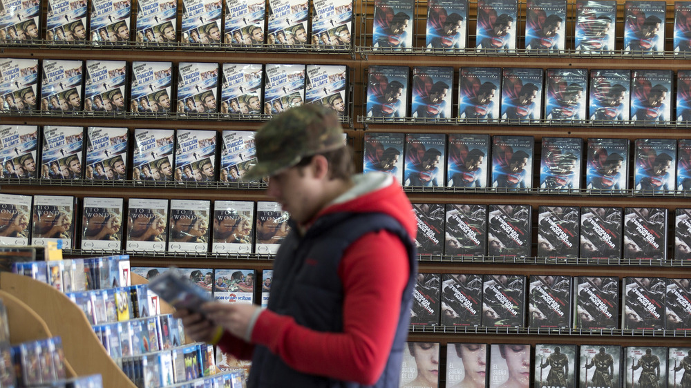 Customer browses video store titles