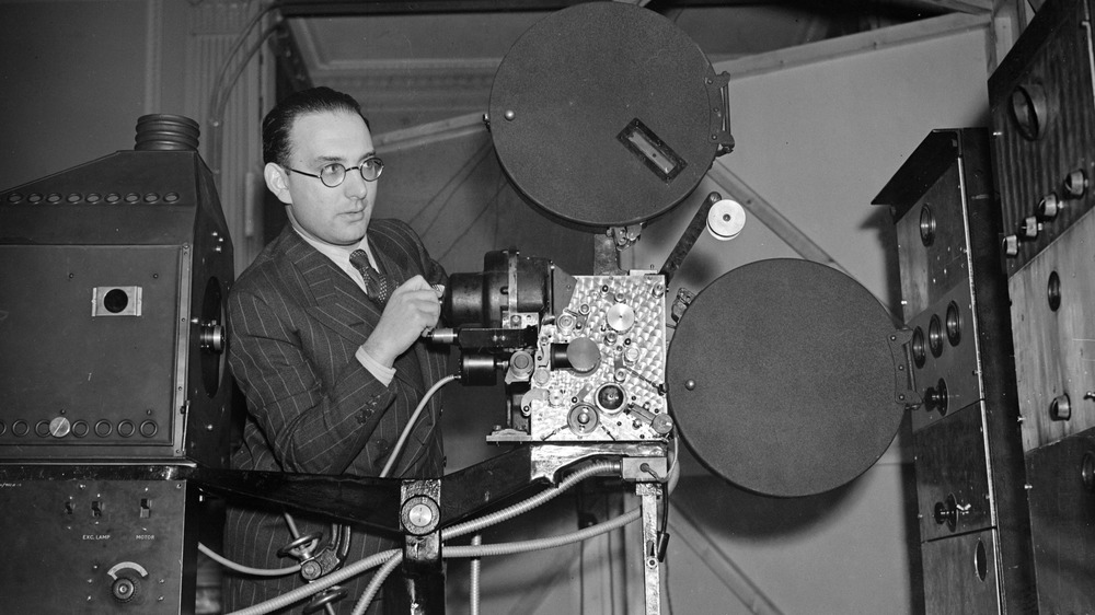 man operating film projector
