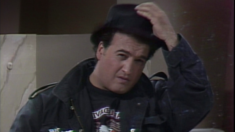 Belushi lifting his hat