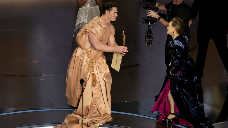 Oscars 2024 John Cena giving award to Holly Waddington