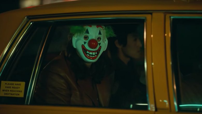 A clown-masked man in Joker