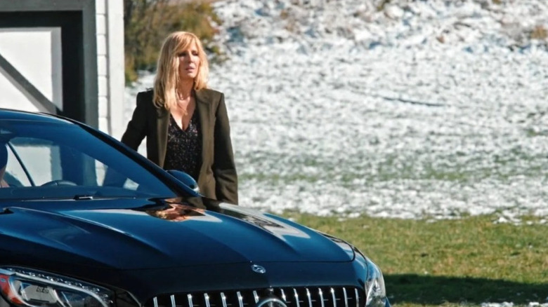 Beth stands next to her Coupe outside in "Yellowstone"