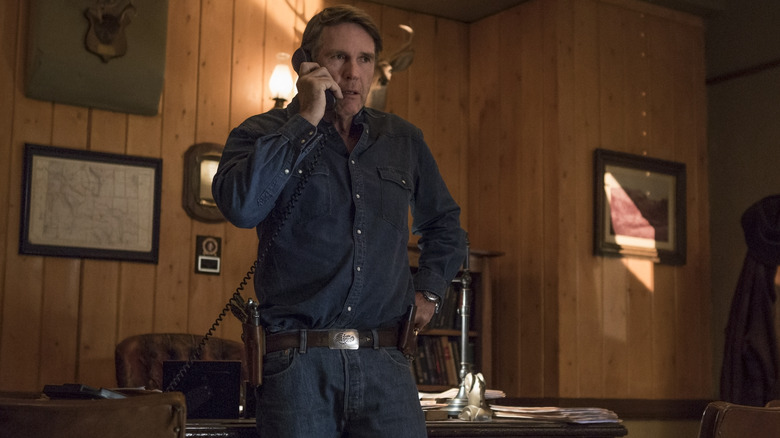 Walt Longmire talking on the phone