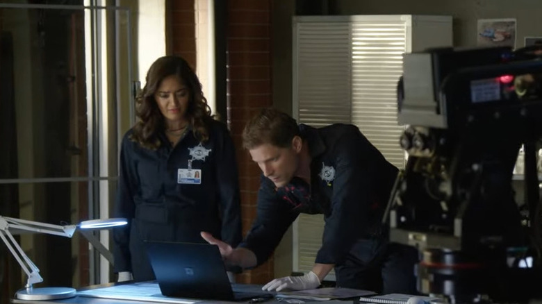 Mandeep Dhillon and Matt Lauria searching for clues