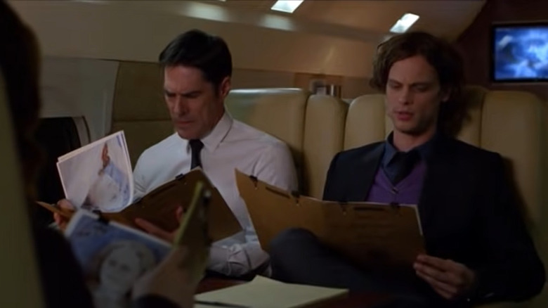 Aaron Hotchner and Dr. Spencer Reid looking into files on the BAU jet