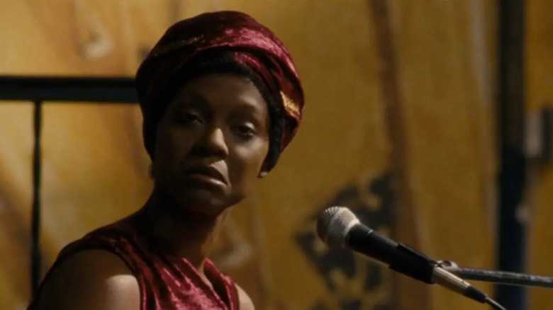 Zoe Saldana singing into microphone