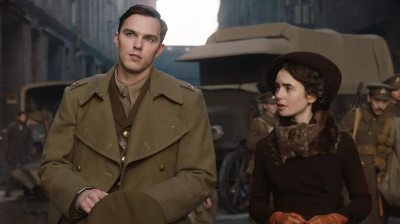 Nicholas Hoult and Lilly Collins standing