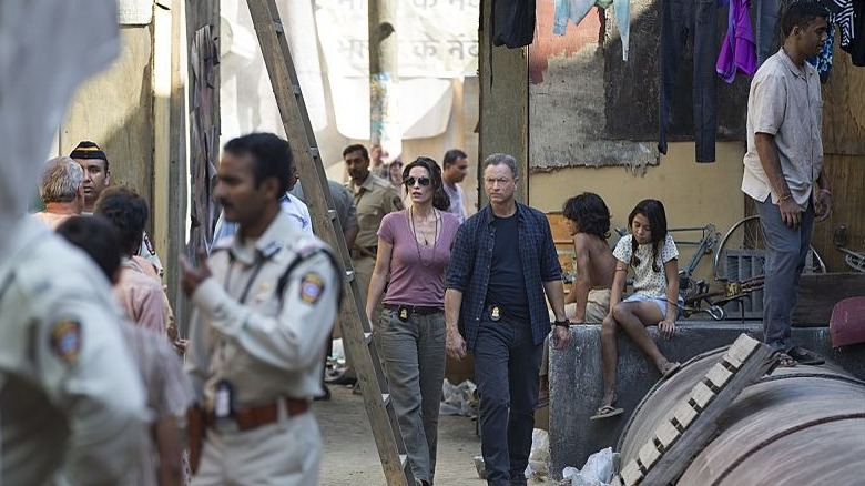 Alana de la Garza and Gary Sinise walk in Criminal Minds: Beyond Borders