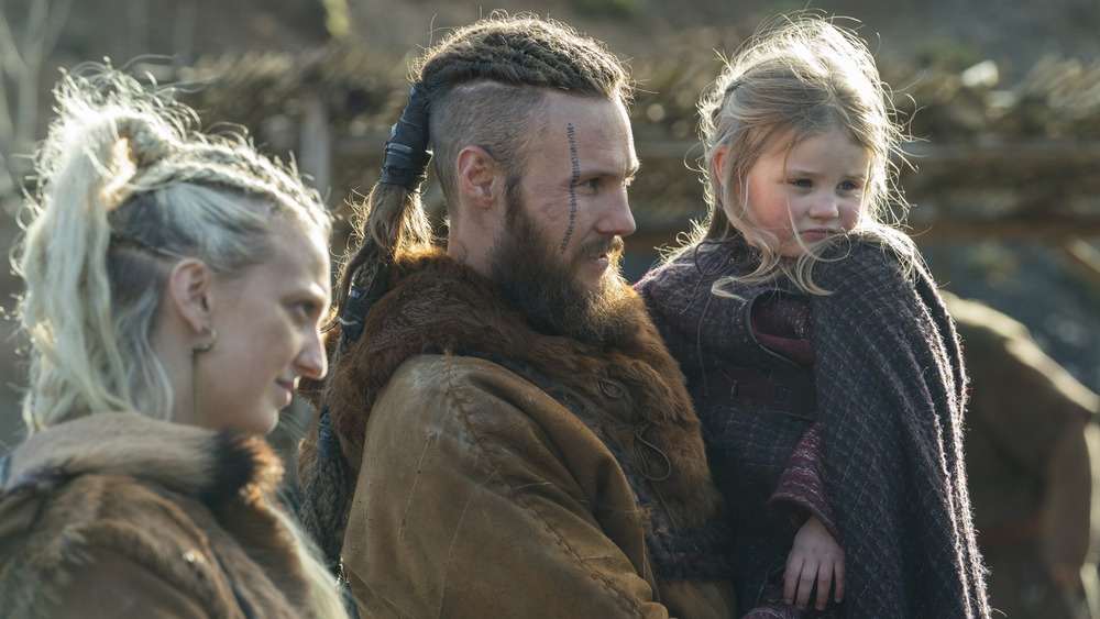 Vikings Ubbe holding son Ragnar with wife Torvi