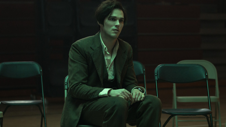 Nicholas Hoult's Renfield sits on a chair