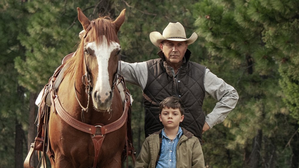 John Dutton (Kevin Costner) stands with his grandson Tate on Yellowstone