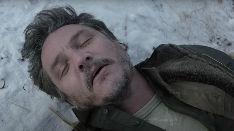 Pedro Pascal as Joel collapsed on ground