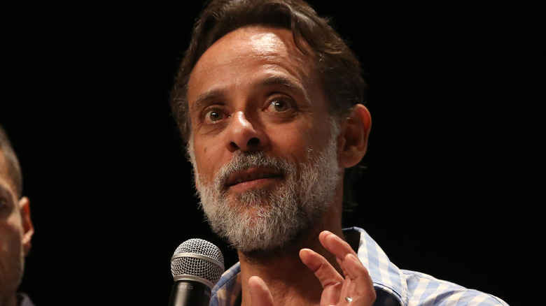 Alexander Siddig with a microphone