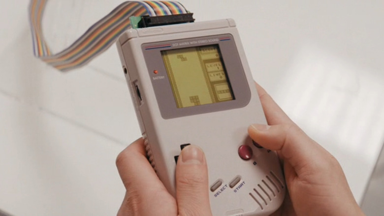 A person plays the Game Boy